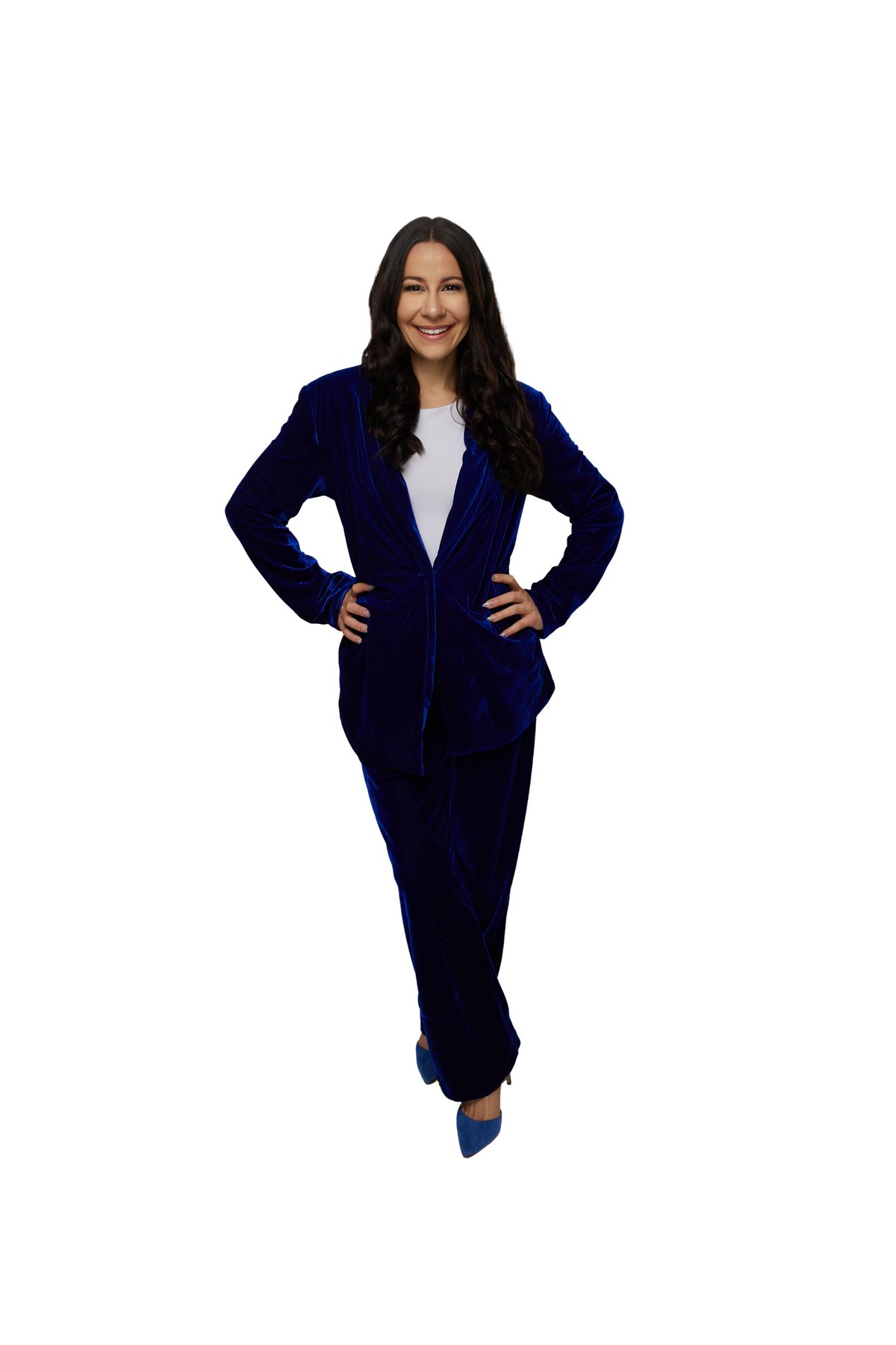 Bryanna Baptiste in a royal blue velvet suit with her hands on her hips, on a white background